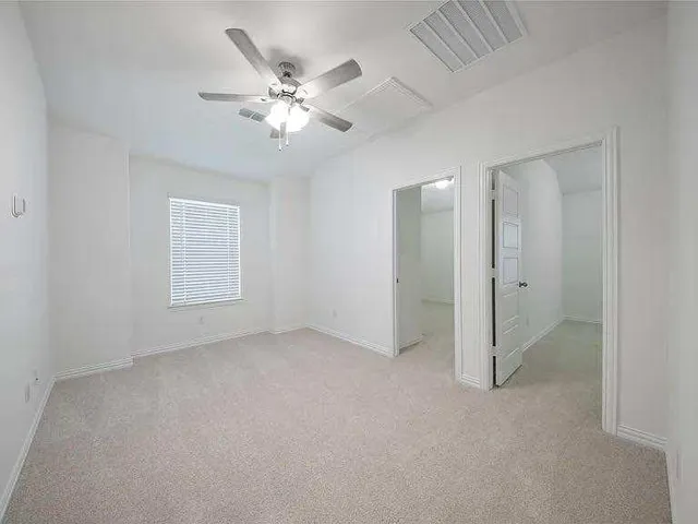 a white bath tub sitting next to a shower