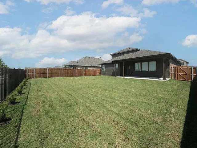 a large kitchen with a large window and stainless steel appliances