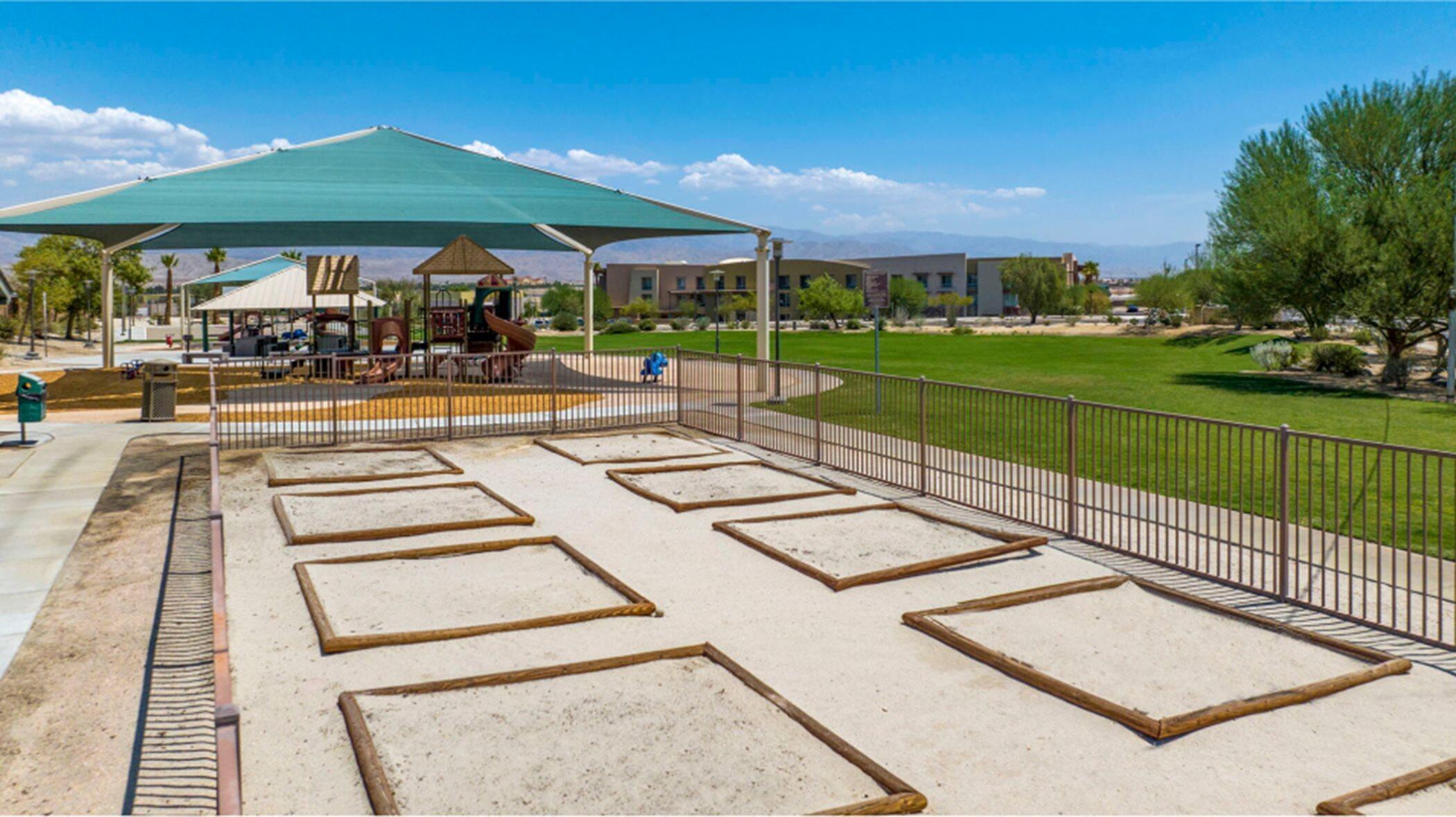 76273 Cornell Way Palm Desert, CA 92211 - Photo 16 of 16 a view of a patio with a table and chairs under an umbrella