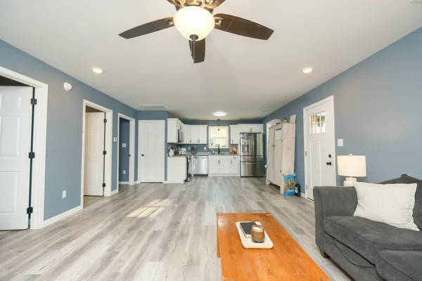 a view of a livingroom with kitchen and furniture