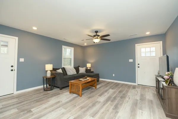 a living room with furniture and wooden floor