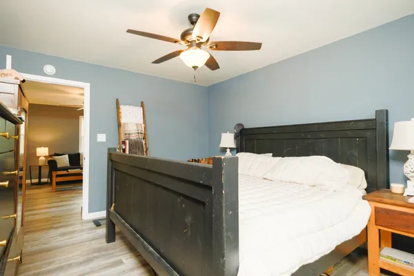 a bed room with a bed and a chandelier