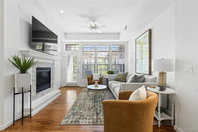 a living room with fireplace furniture and a flat screen tv