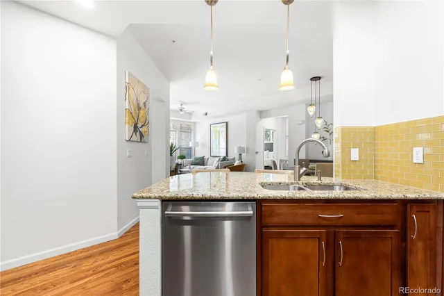 a kitchen with stainless steel appliances granite countertop a sink a refrigerator and a granite counter tops