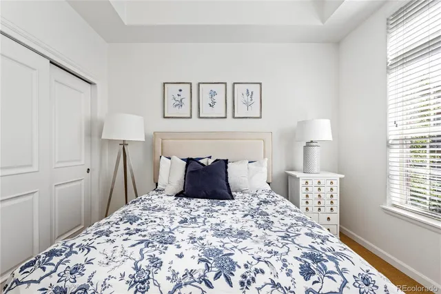 a large bed in a bedroom next to a window