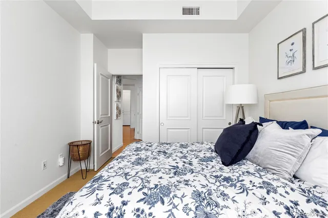 a bedroom with a bed and a lamp