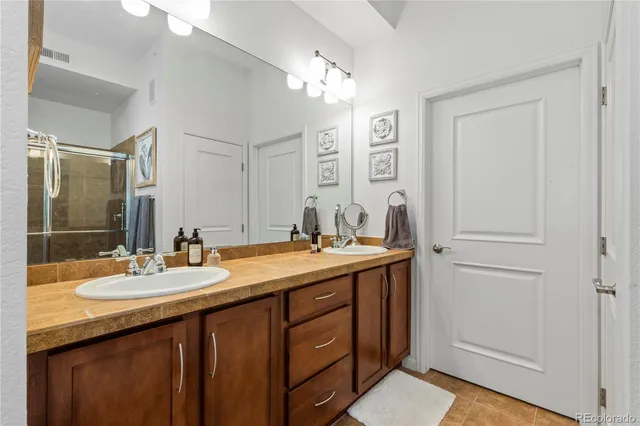a bathroom with a double vanity sink and a mirror