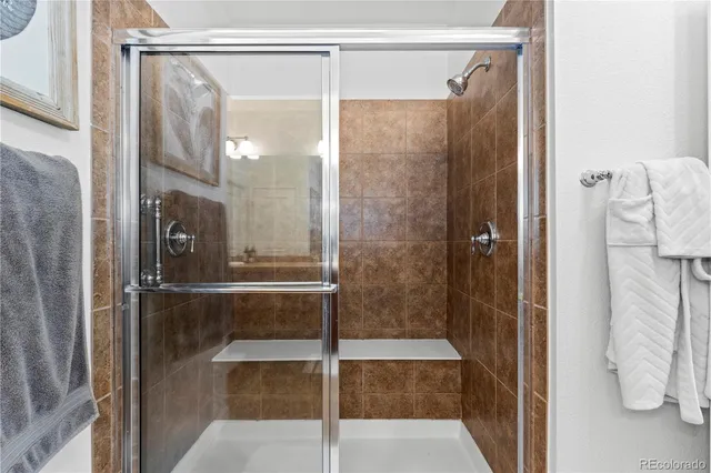 a bathroom with a glass shower door