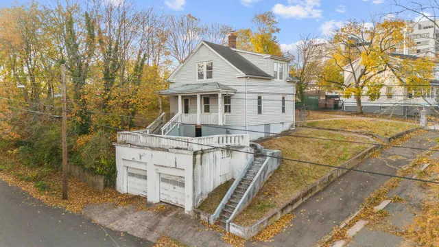 a front view of a house with trees