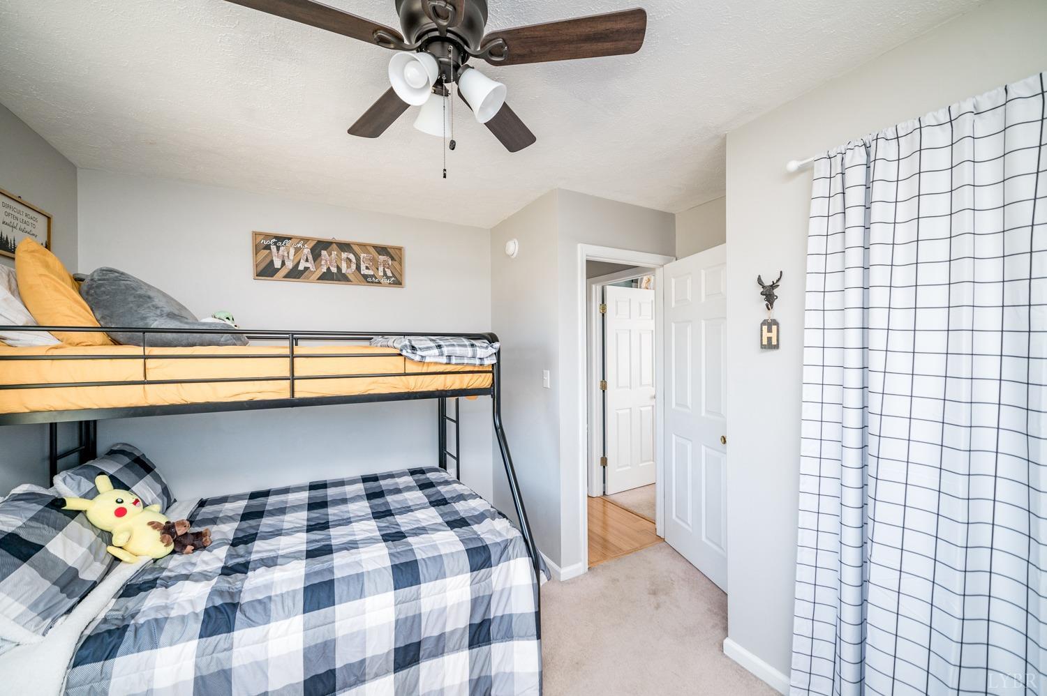 1077 Terrace View Road Goode, VA 24556 - Photo 15 of 54 a bedroom with a bed and a chandelier