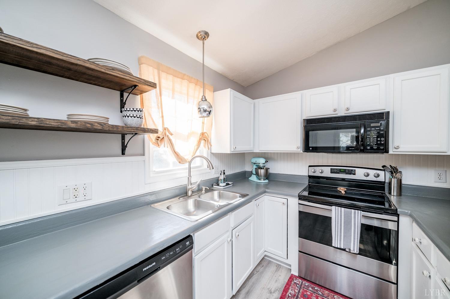 1077 Terrace View Road Goode, VA 24556 - Photo 8 of 54 a kitchen with a sink stove and microwave