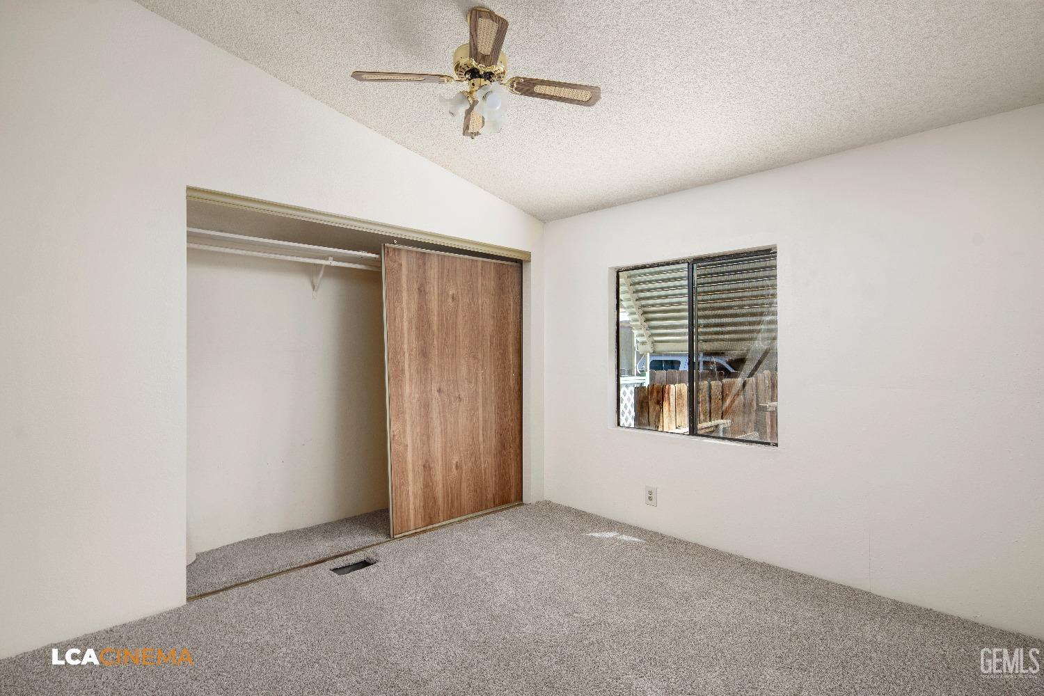 Undisclosed Address Bakersfield, CA 93307 - Photo 11 of 20 an empty room with windows and fan