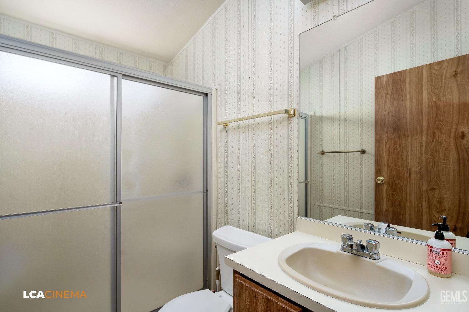 Undisclosed Address Bakersfield, CA 93307 - Photo 13 of 20 a bathroom with a sink and a mirror