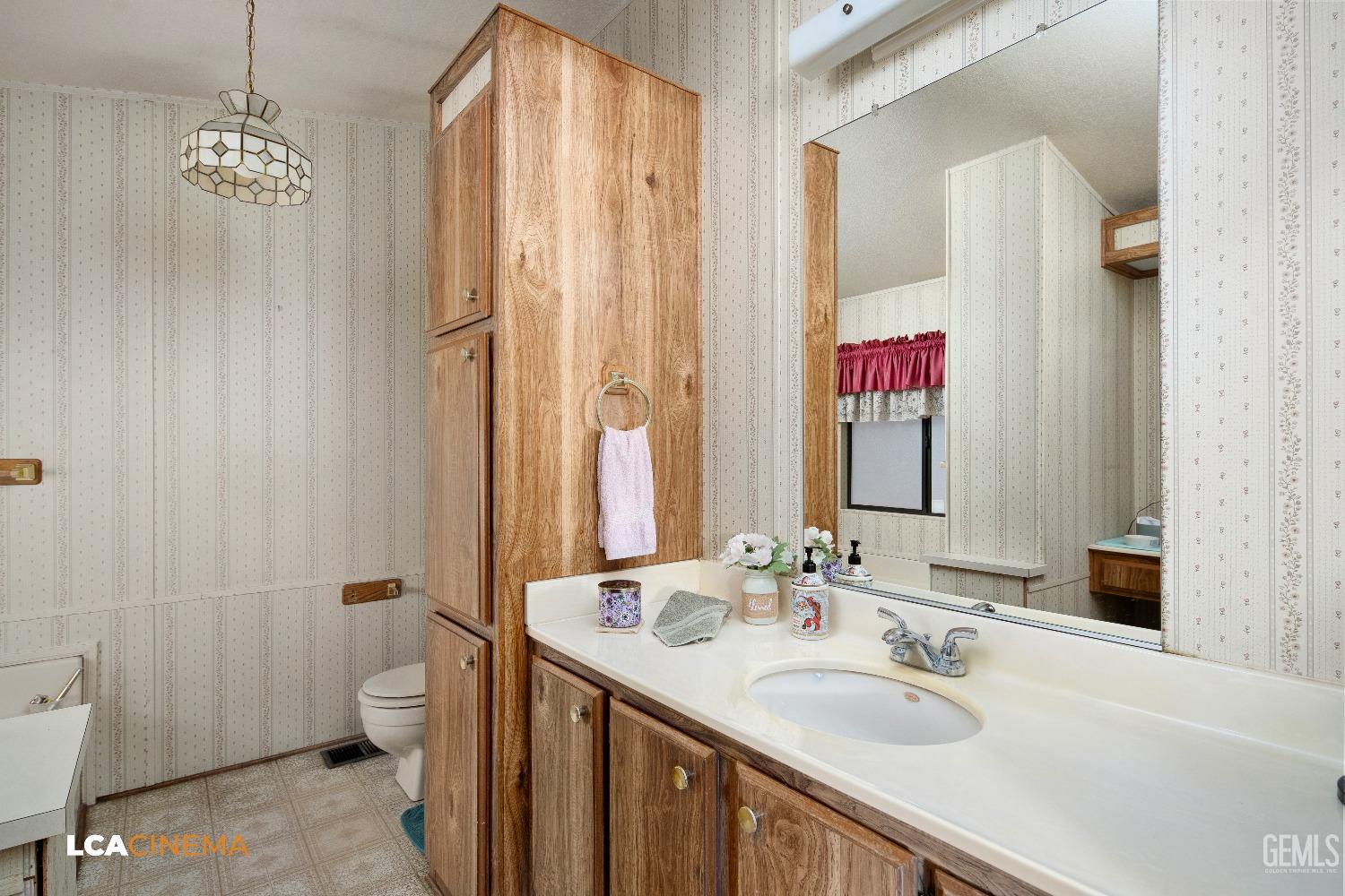 Undisclosed Address Bakersfield, CA 93307 - Photo 14 of 20 a bathroom with a sink and a mirror