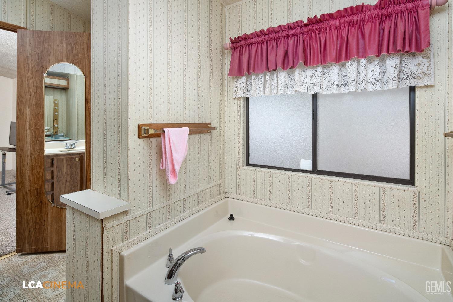 Undisclosed Address Bakersfield, CA 93307 - Photo 15 of 20 a bathroom with a bathtub and shower