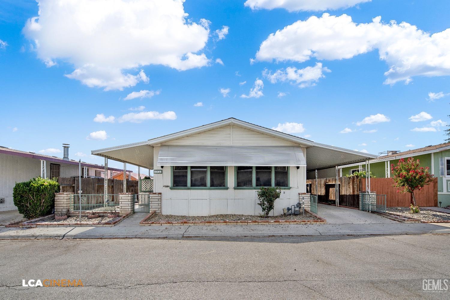 Undisclosed Address Bakersfield, CA 93307 - Photo 20 of 20 a front view of a house with a yard and garage