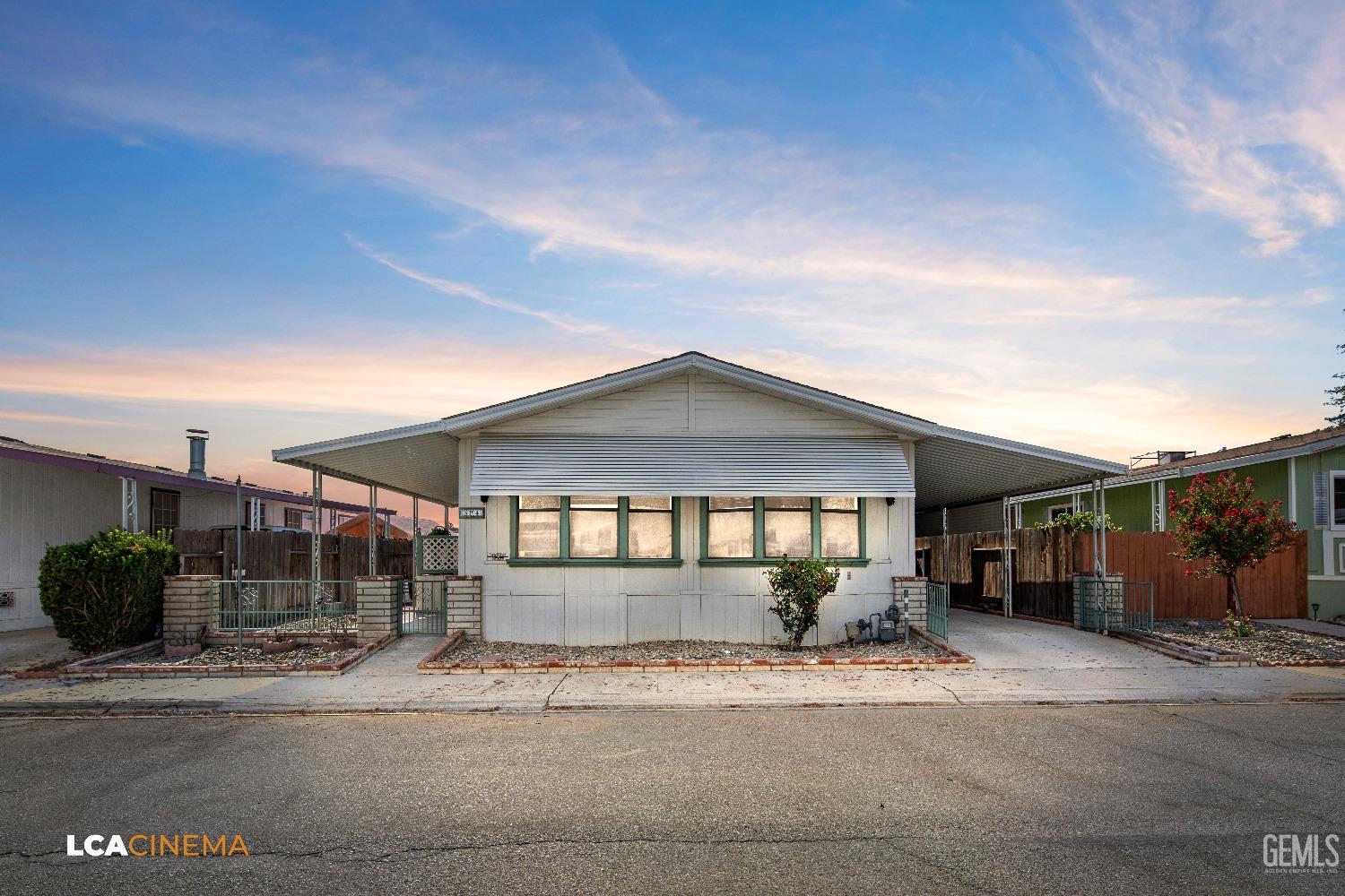 Undisclosed Address Bakersfield, CA 93307 - Photo 3 of 20 a front view of a house with a yard and potted plants