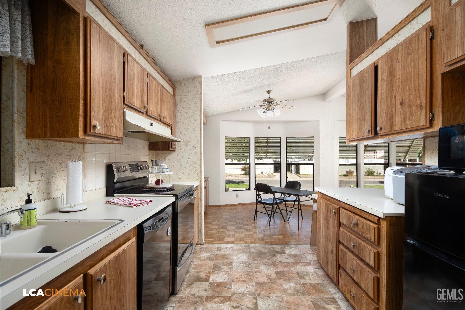 Undisclosed Address Bakersfield, CA 93307 - Photo 6 of 20 a kitchen with granite countertop a sink stove and cabinets