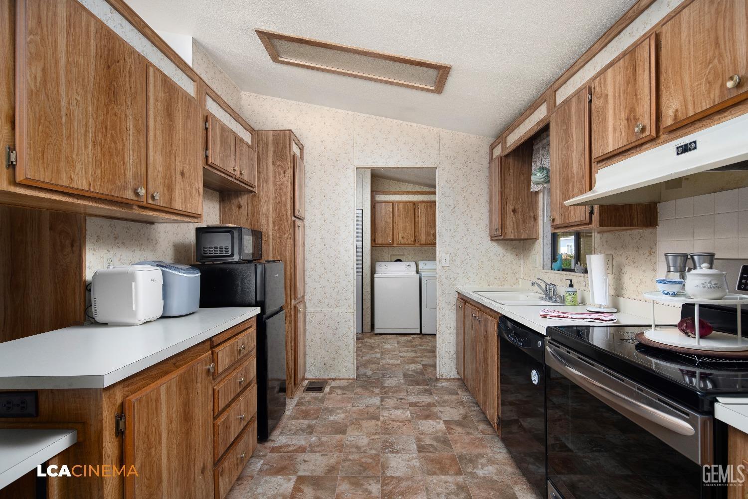 Undisclosed Address Bakersfield, CA 93307 - Photo 7 of 20 a kitchen with stainless steel appliances granite countertop a sink stove and refrigerator