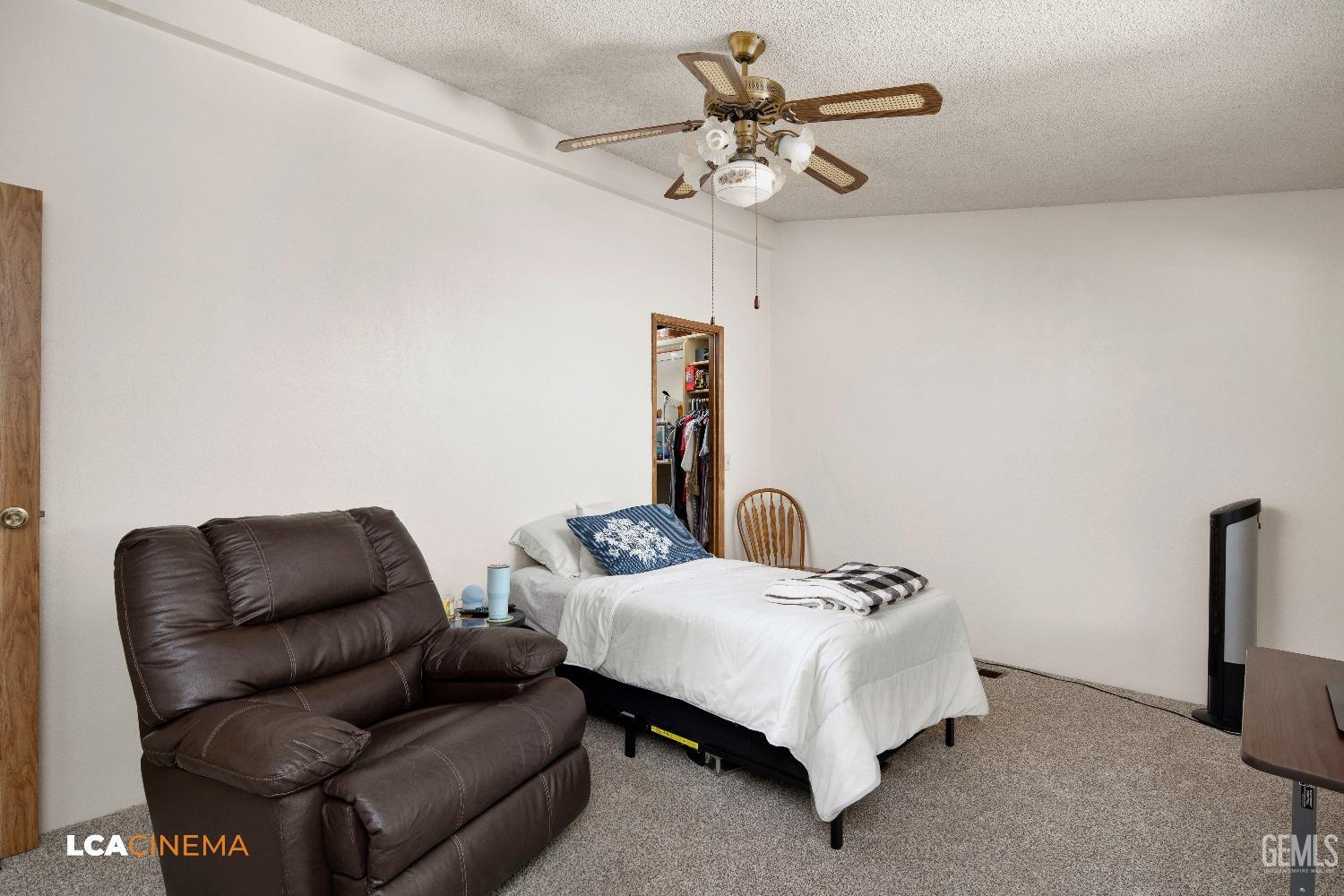 Undisclosed Address Bakersfield, CA 93307 - Photo 9 of 20 a bedroom with furniture and a chandelier