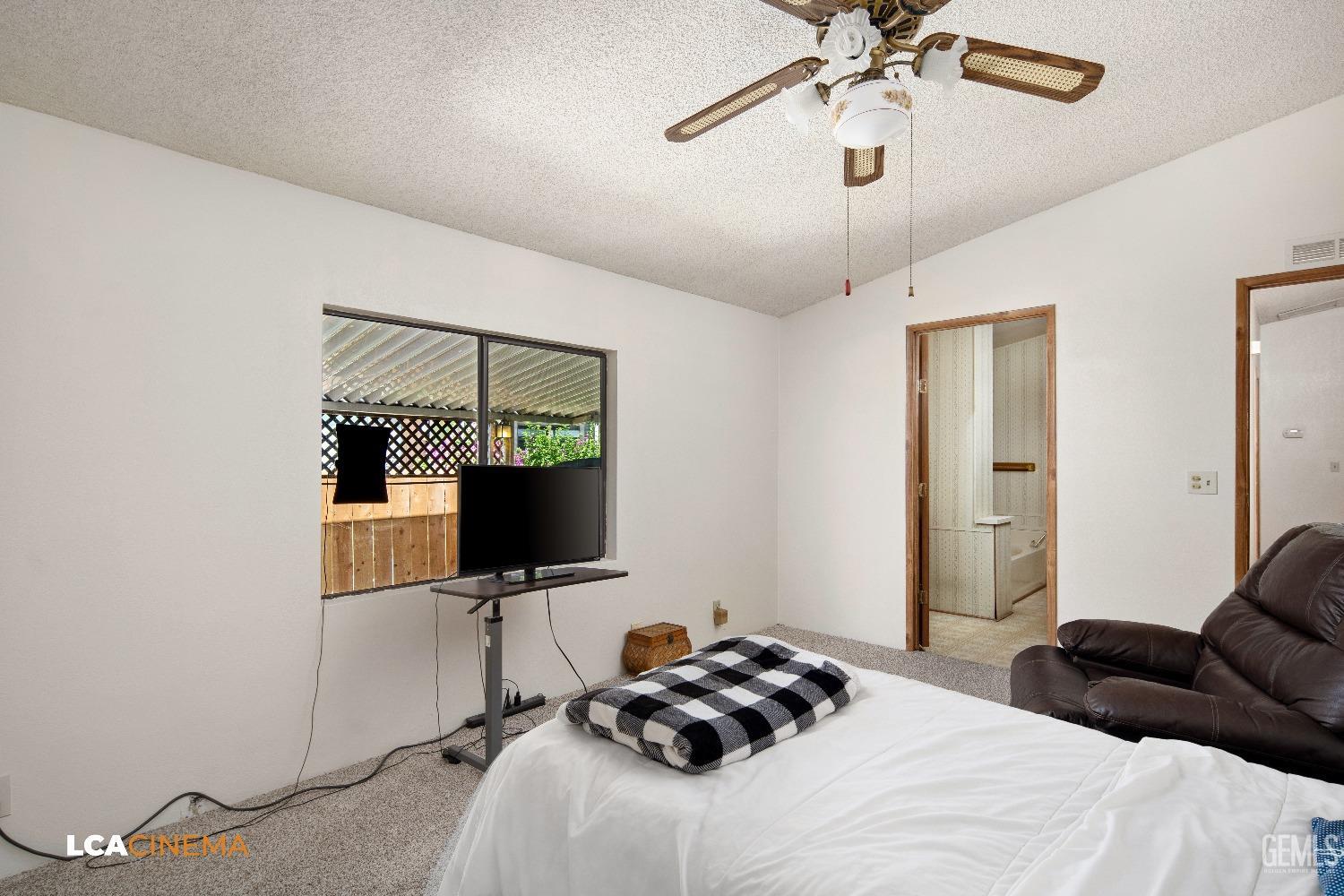 Undisclosed Address Bakersfield, CA 93307 - Photo 10 of 20 a bedroom with a bed and a flat screen tv