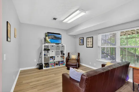 a living room with furniture and a book shelf