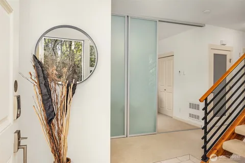 a view of a livingroom with wooden floor and a ceiling fan