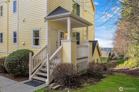 a view of a house with brick walls and wooden fence