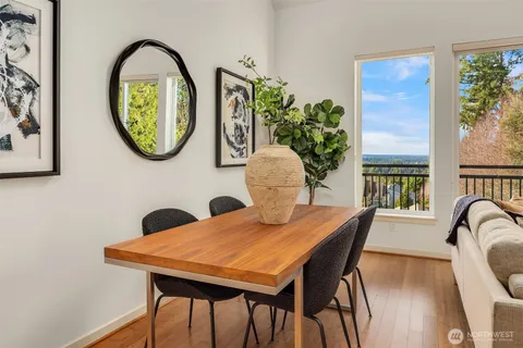 a view of a dining room with furniture and a potted plant