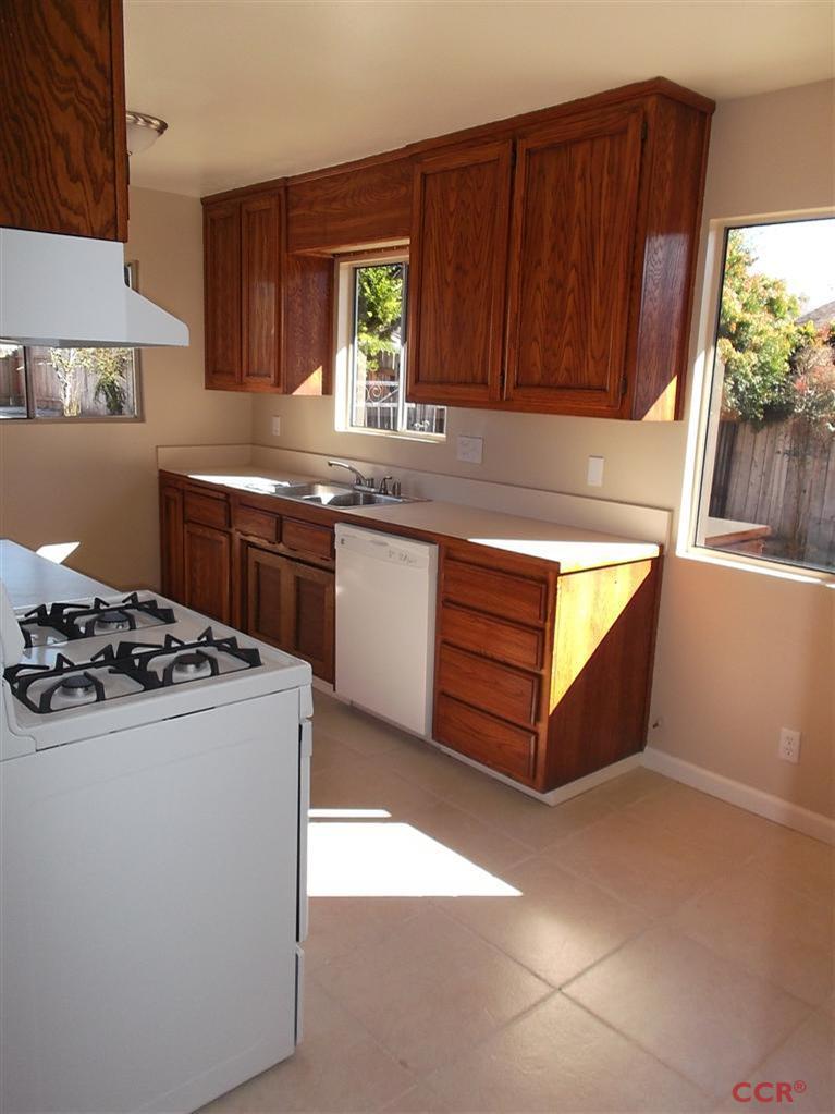 404 North A Street Lompoc, CA 93436 - Photo 3 of 15 a kitchen with stainless steel appliances a stove a sink and a microwave