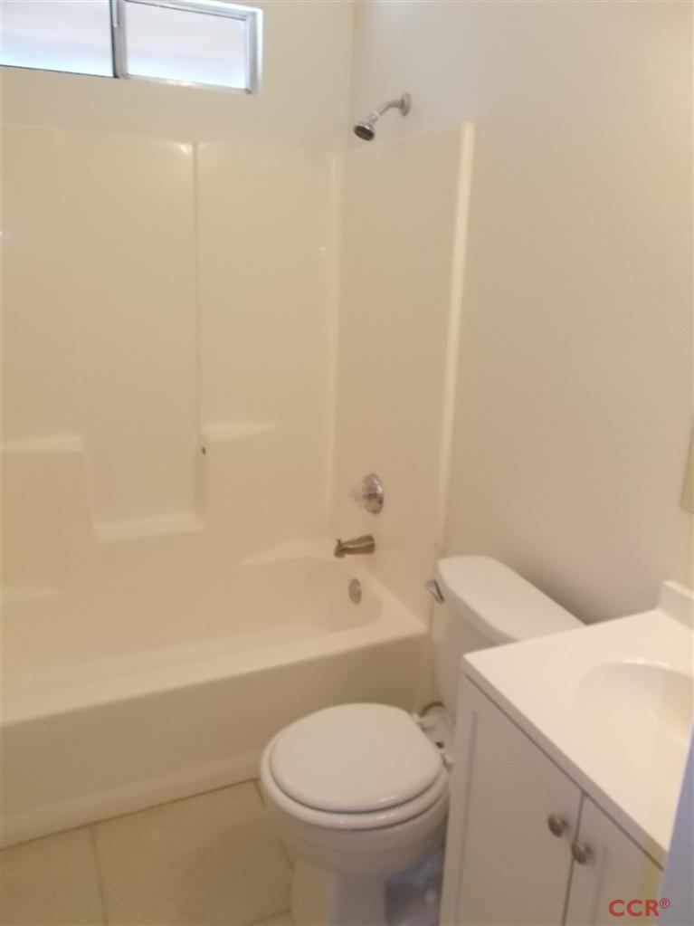 404 North A Street Lompoc, CA 93436 - Photo 9 of 15 a white toilet sitting next to a bath tub