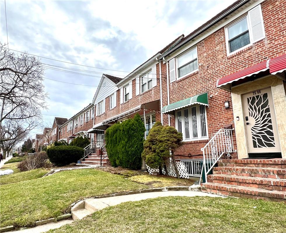 a front view of a house with a yard