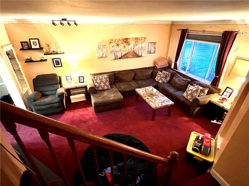 75-06 Utopia Parkway Queens, NY 11366 - Photo 3 of 9 a living room with furniture and wooden floor