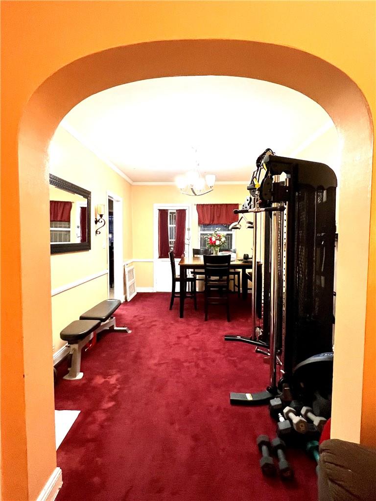 75-06 Utopia Parkway Queens, NY 11366 - Photo 4 of 9 a living room with furniture and a flat screen tv