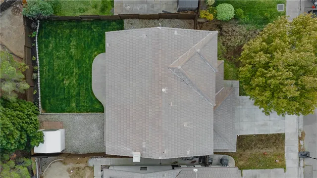 an aerial view of a house with a yard