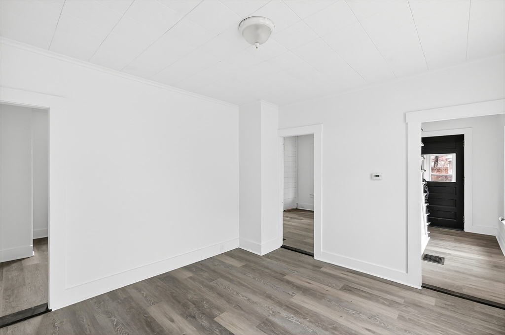 150 East Main Street Orange, MA 01364 - Photo 13 of 41 an empty room with wooden floor and closet