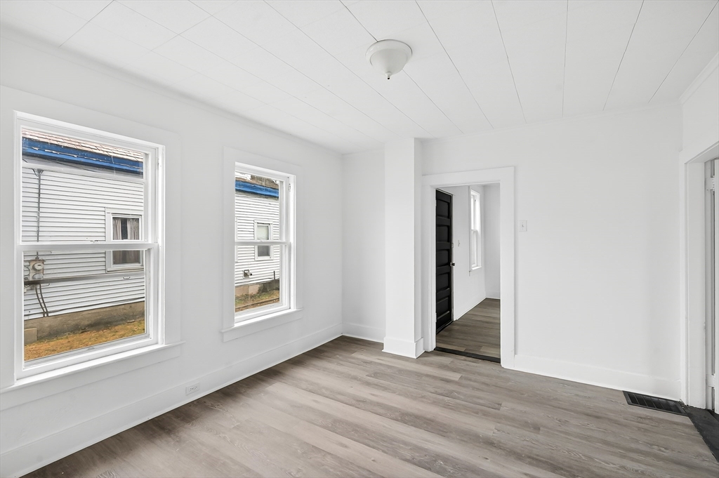 150 East Main Street Orange, MA 01364 - Photo 14 of 41 a view of an empty room with wooden floor and a window