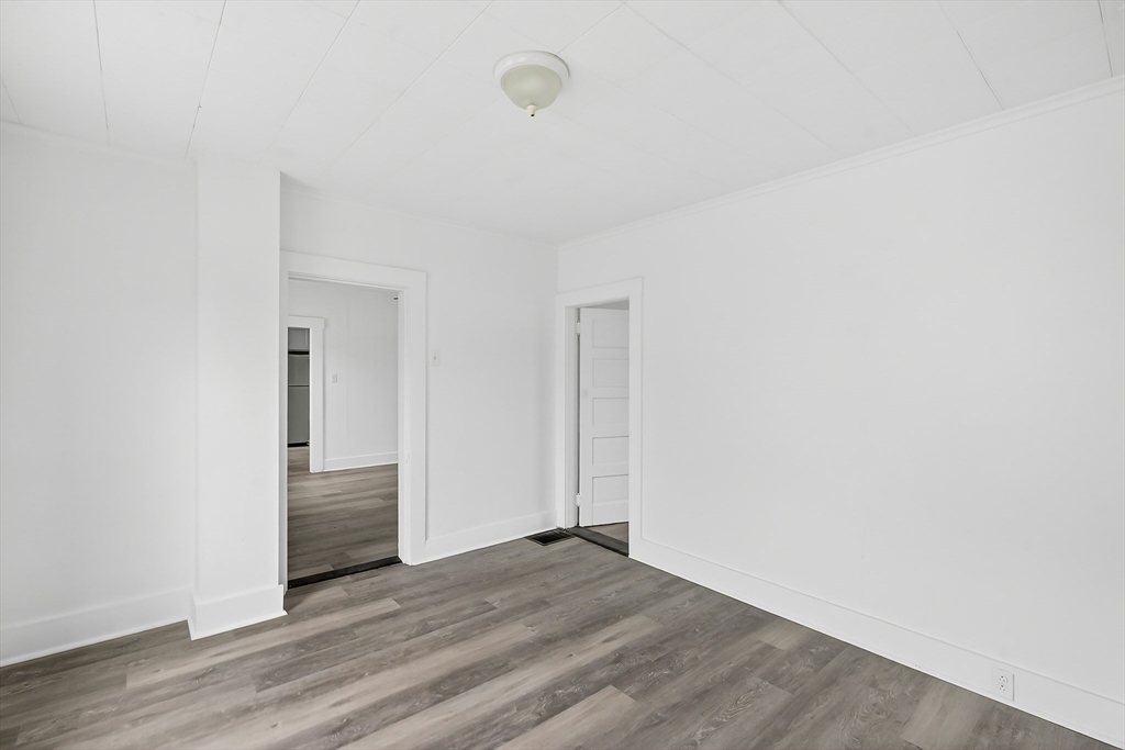 150 East Main Street Orange, MA 01364 - Photo 15 of 41 a view of an empty room with wooden floor and closet