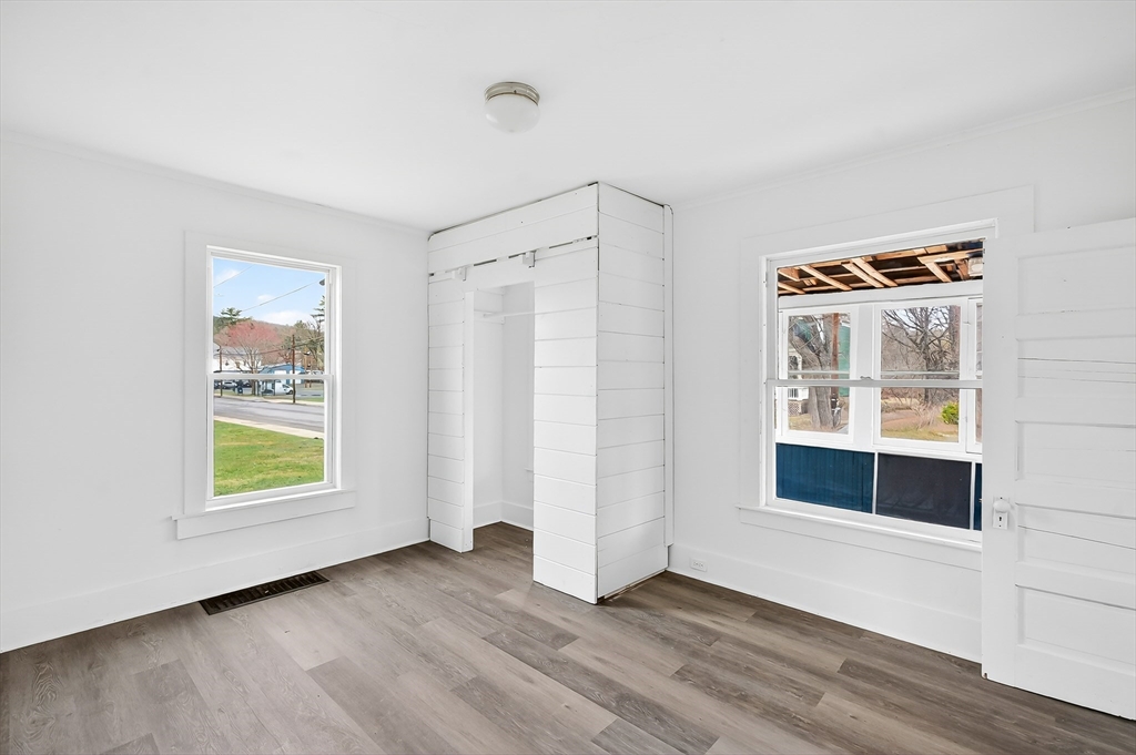 150 East Main Street Orange, MA 01364 - Photo 18 of 41 an empty room with wooden floor and windows
