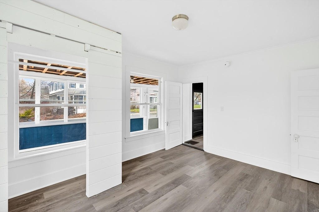 150 East Main Street Orange, MA 01364 - Photo 19 of 41 a view of an empty room with wooden floor and a window