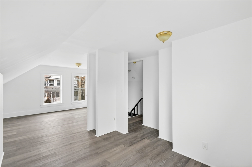 150 East Main Street Orange, MA 01364 - Photo 24 of 41 a view of a hallway with wooden floor and a living room