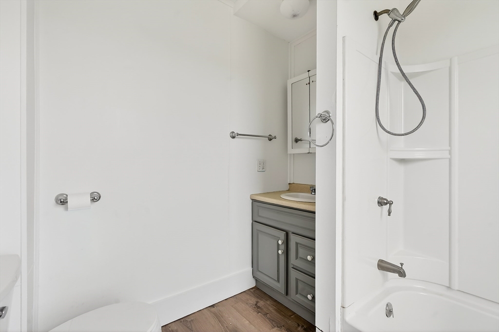 150 East Main Street Orange, MA 01364 - Photo 8 of 41 a bathroom with a granite countertop sink a toilet and shower