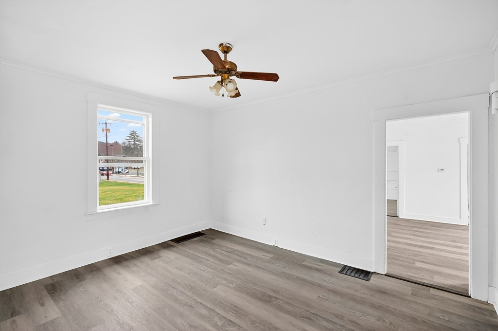 150 East Main Street Orange, MA 01364 - Photo 9 of 41 an empty room with wooden floor closet and windows