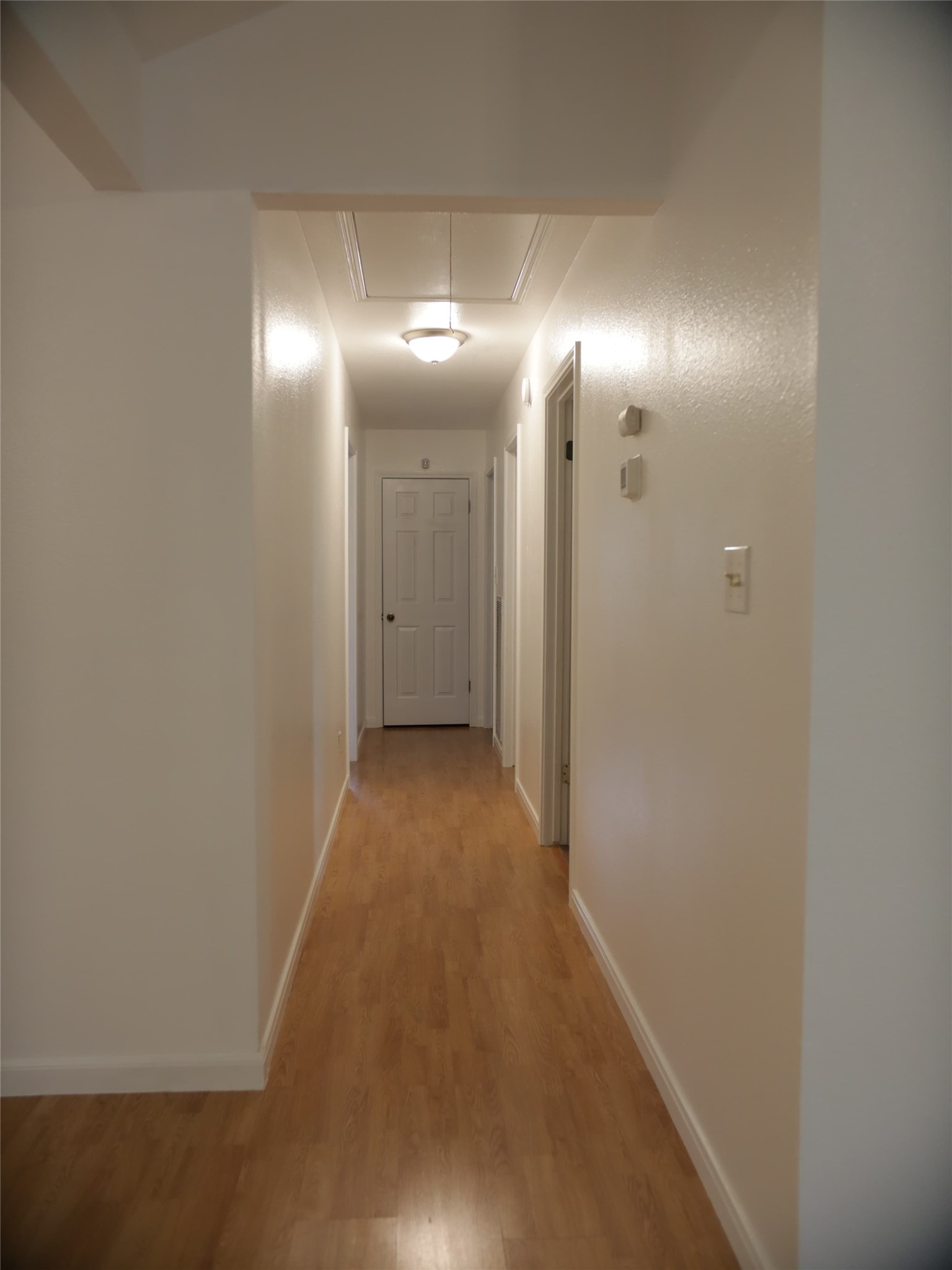 1612 Buttercup Road Pflugerville, TX 78660 - Photo 9 of 16 A well-lit corridor with warm wood-tone flooring creates a welcoming transition.