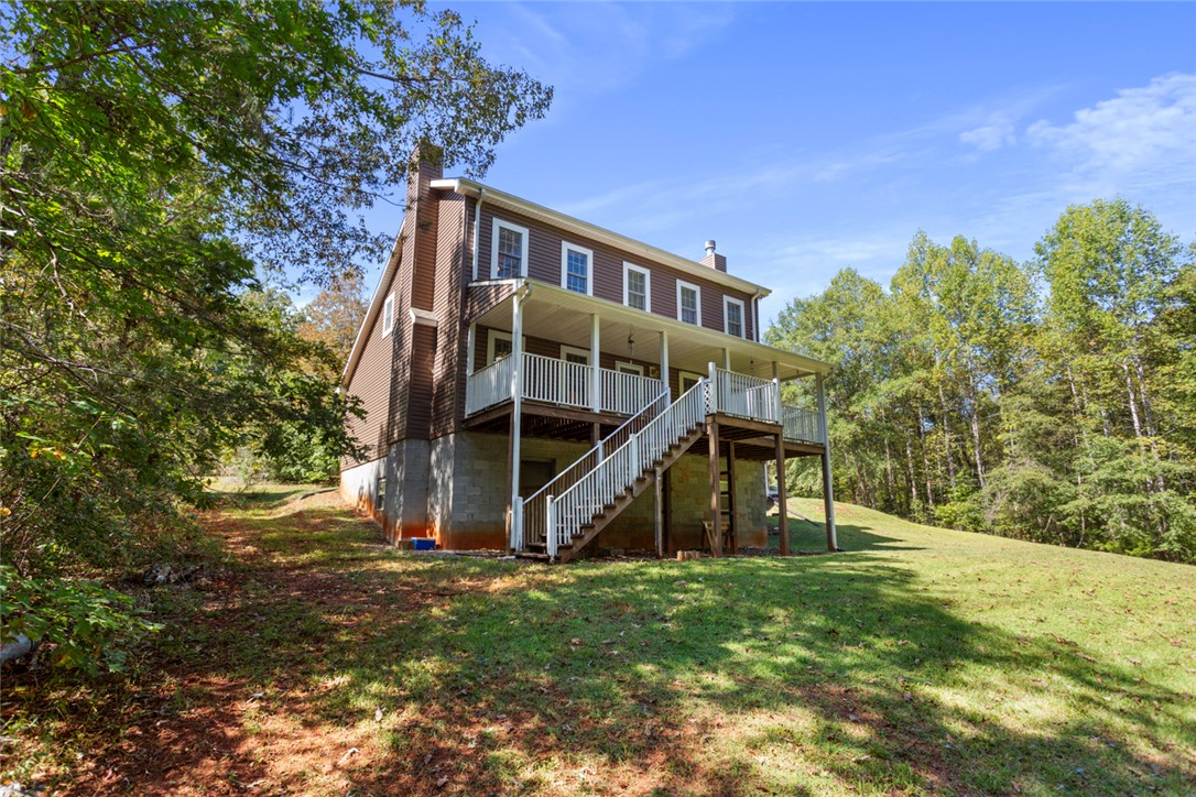 621 Burns Mill Road West Union, SC 29696 - Photo 26 of 45 A spacious raised deck and porch overlook a verdant, tree-lined landscape.