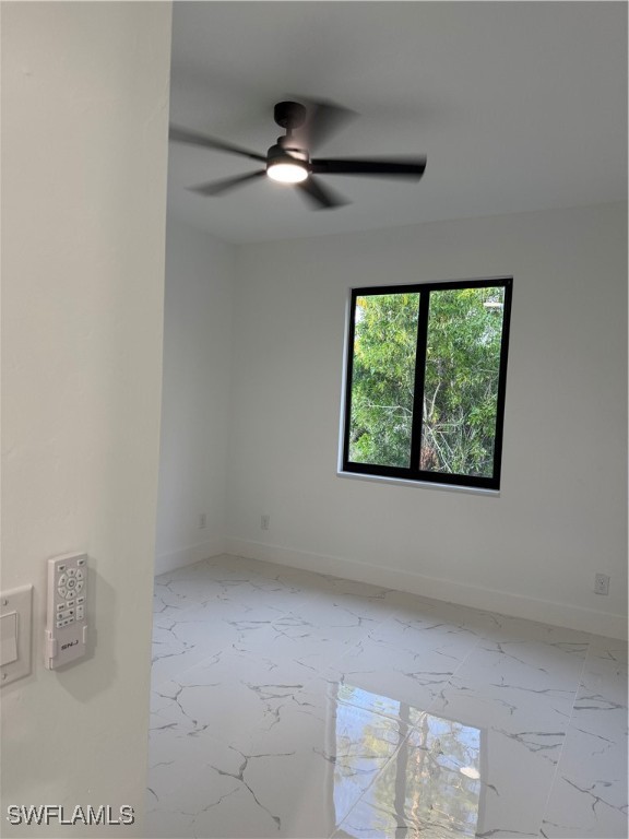 3701 East 3rd Street Lehigh Acres, FL 33936 - Photo 13 of 19 an empty room with windows and chandelier fan