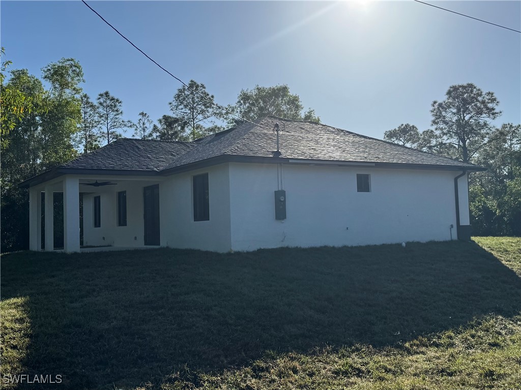 3701 East 3rd Street Lehigh Acres, FL 33936 - Photo 2 of 19 a view of a house with a yard