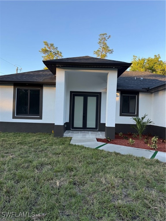 3701 East 3rd Street Lehigh Acres, FL 33936 - Photo 3 of 19 a front view of a house with a yard