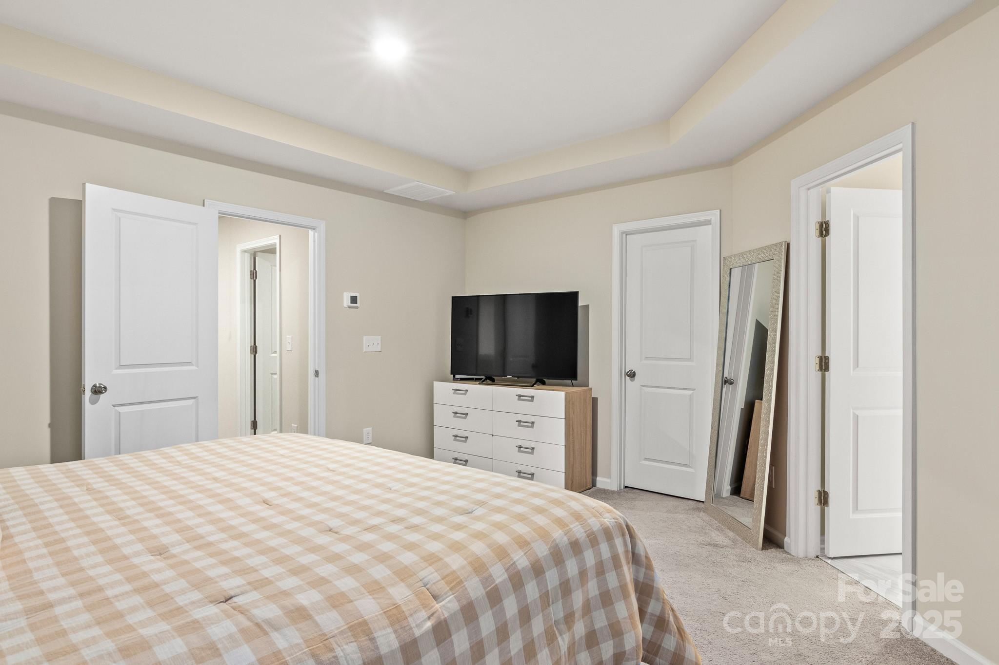 804 Gable Oak Lane Fort Mill, SC 29708 - Photo 17 of 26 a bedroom with a bed and a flat screen tv