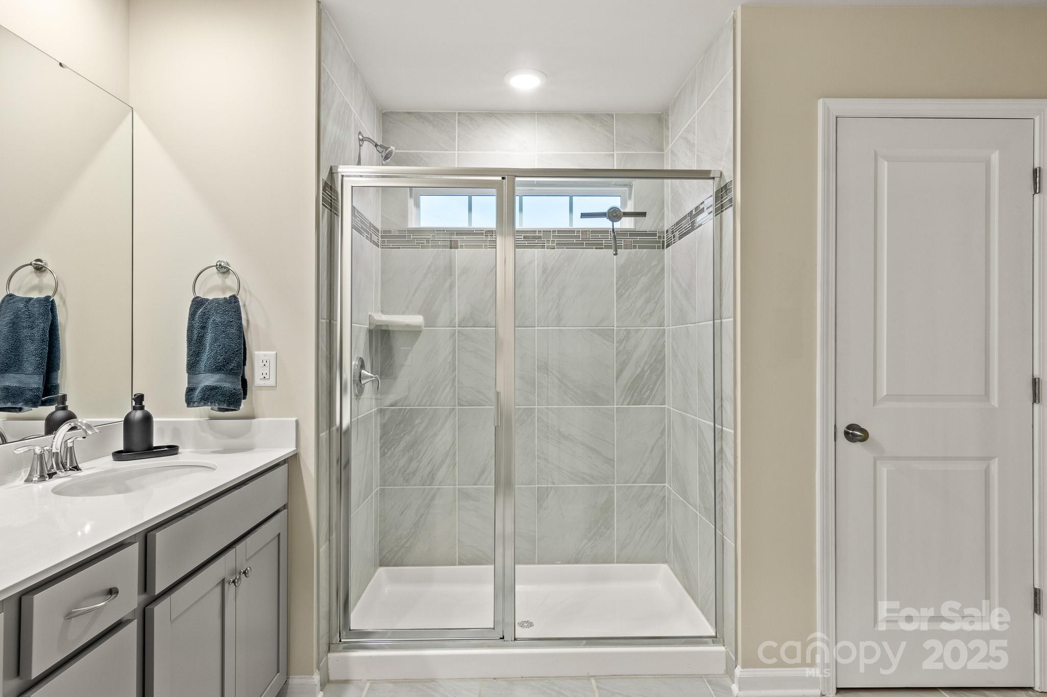 804 Gable Oak Lane Fort Mill, SC 29708 - Photo 19 of 26 a bathroom with a shower sink and mirror
